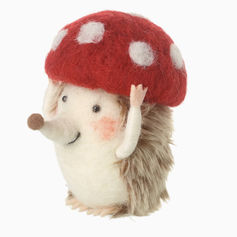 Felt hedgehog Christmas decoration wearing a red toadstool hat
