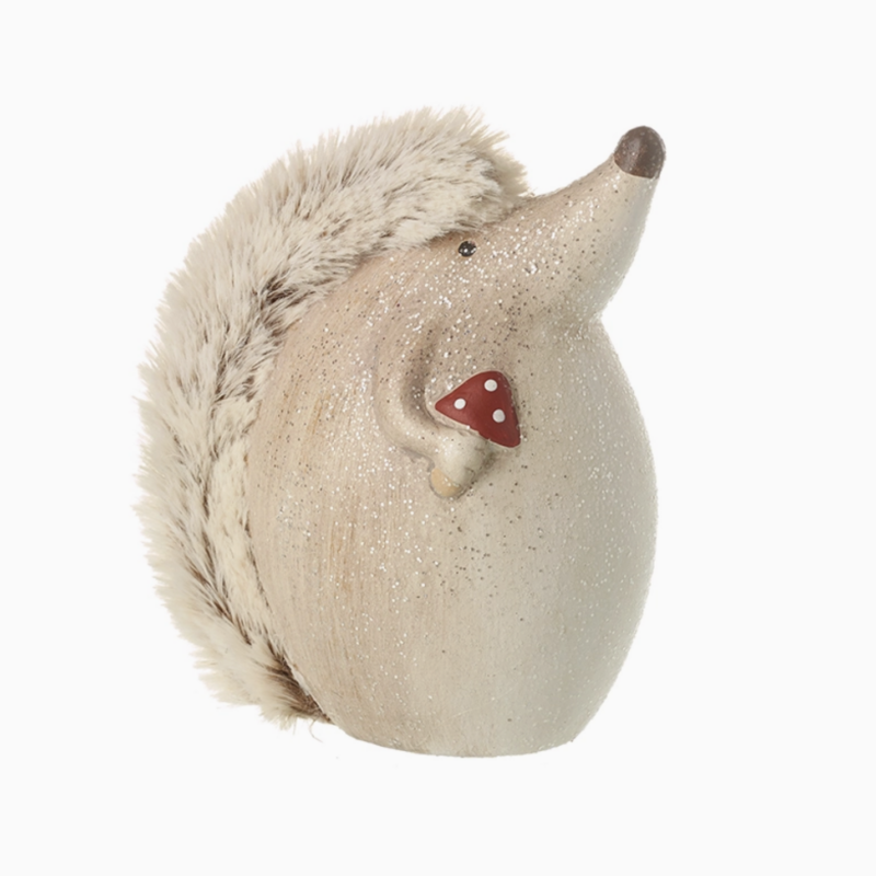 Hedgehog ornament holding a red spotted toadstool